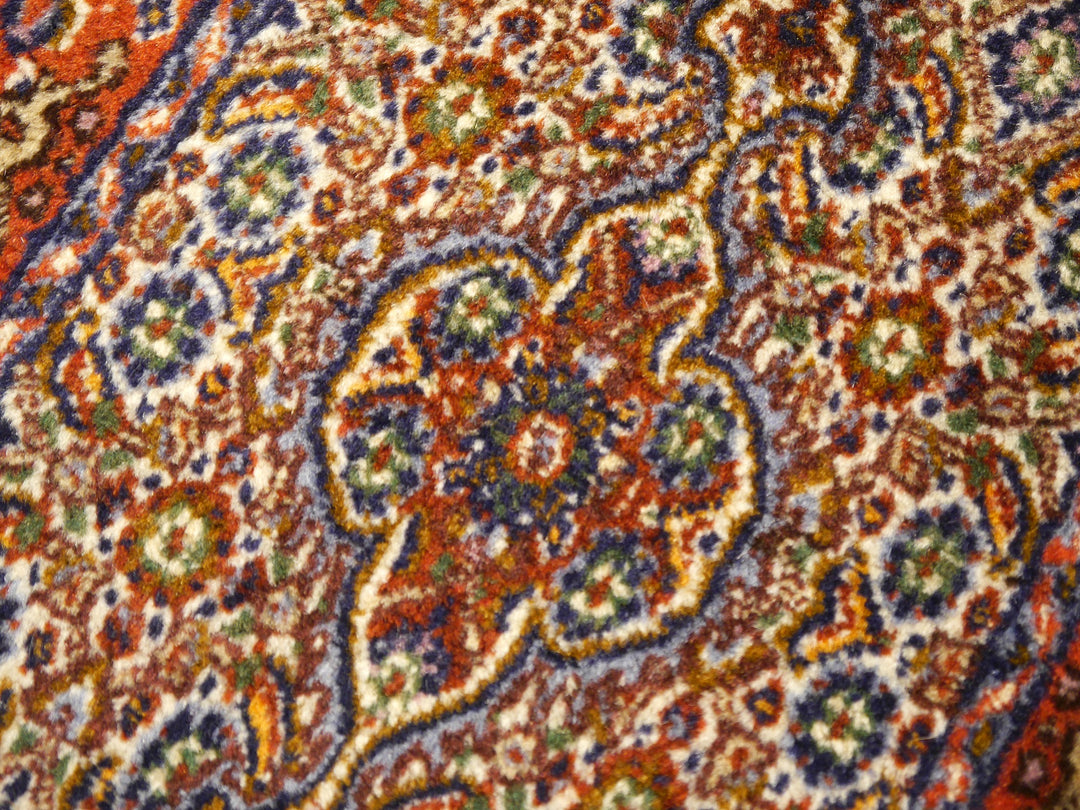 Detail of the small cusped centre medallion in rust red and indigo on the ivory field | 13377