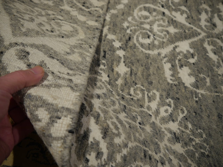 Heathered grey ground spun from several tones, with darker charcoal flecks | 15745