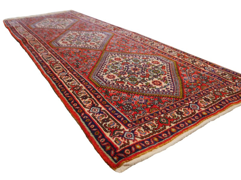 Angled view along the Tekab Bidjar runner showing all three ivory medallions and the dense 12 mm new-wool pile